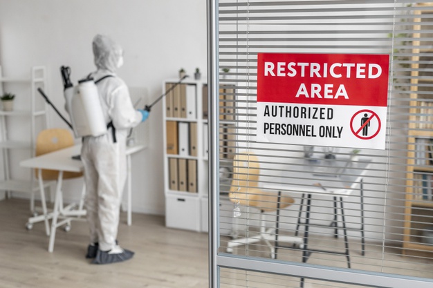 person-disinfecting-restricted-area_23-2148848581